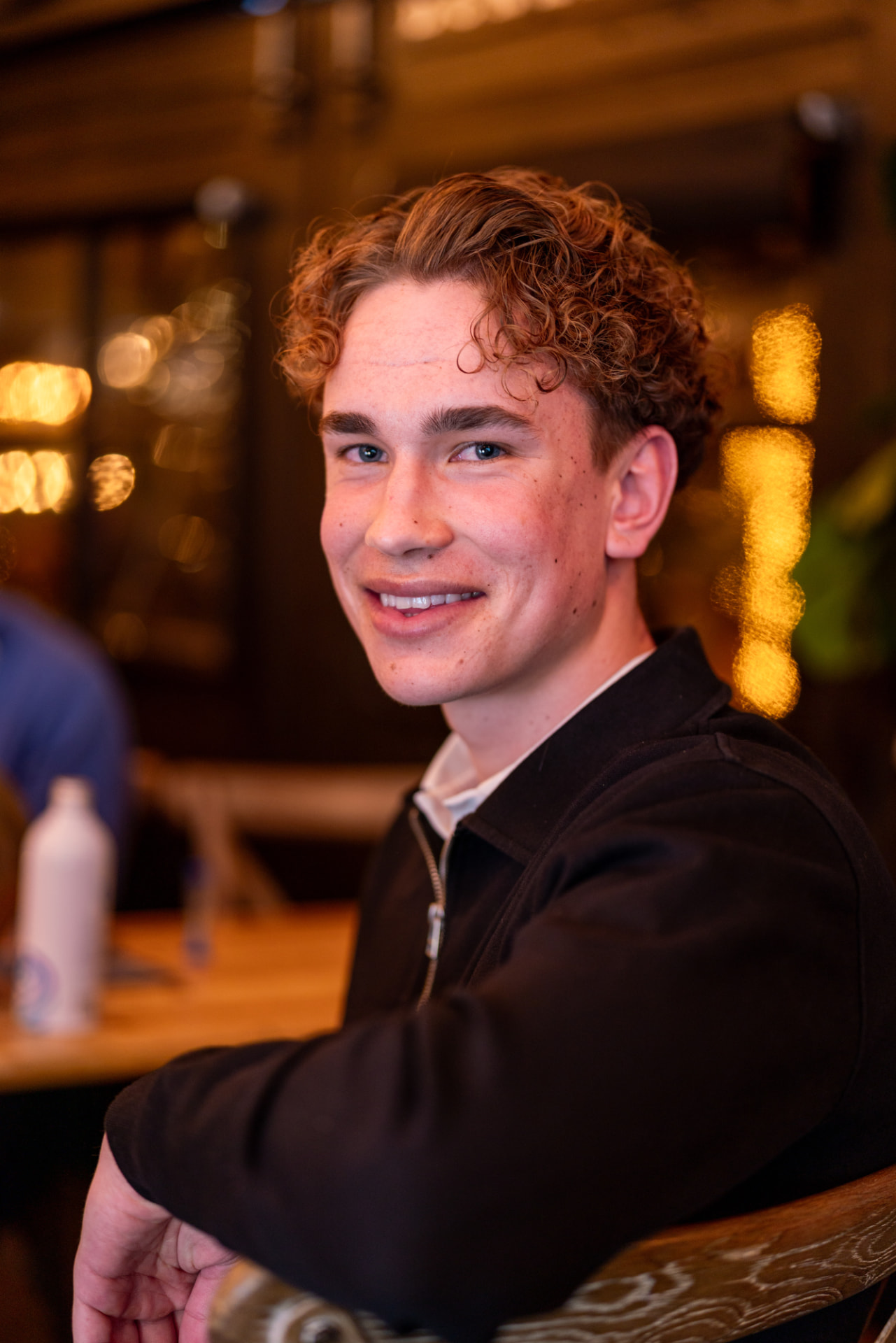 Casper Stanita at a restaurant table, mid-conversation